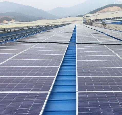 industrial rooftop solar array with tin roof solar mounting systems on a large warehouse metal roof